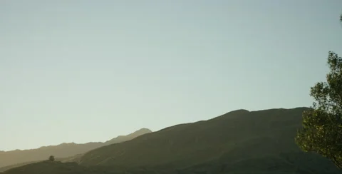 Sun setting over the hill Stock Footage 64449432