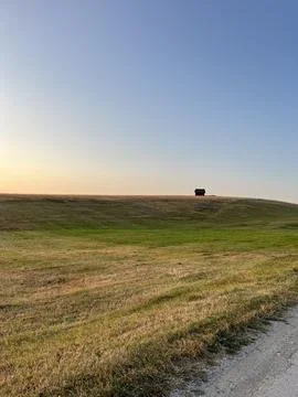 Sun Setting Over Hills and Field, Dramatic Orange Sky Fotos Stock