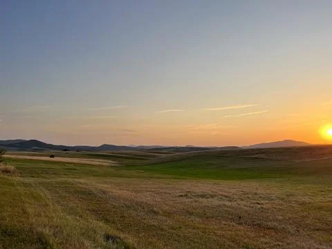 Sun Setting Over Hills and Field, Dramatic Orange Sky Fotos Stock