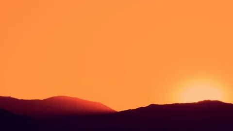 Sun setting over hills Stock Footage 125132180