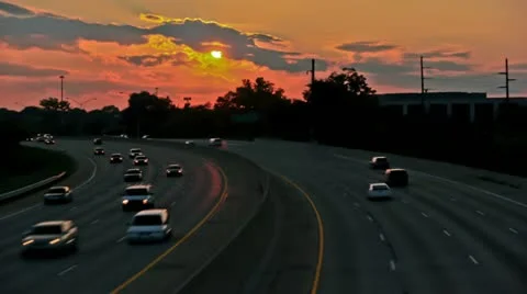 Sun setting over hiway traffic - time lapsed Stock Footage 20471970