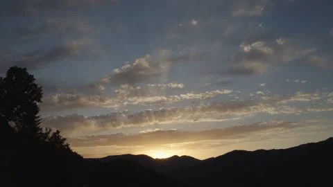 Sun setting over horizon beautiful view with mountain silhouette landscape Stock Footage 223458233