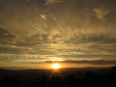 Sun setting over the horizon Stock Photos