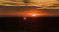 Sun setting over the horizon - Time lapsed HD видео футажи