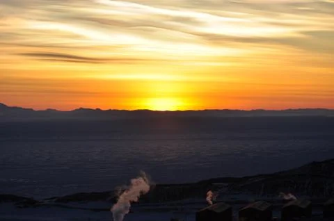 Sun setting over the ice shelf on ross island Stock Photos