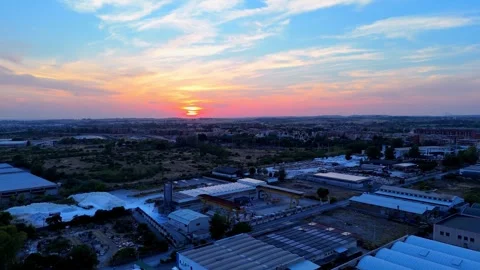 Sun setting over industrial area with colorful sky Stock Footage 282607049