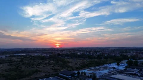 Sun setting over industrial area with orange and purple sky Stock Footage 282882554