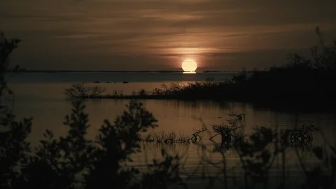 Sun setting over lake Stock Footage 97603626