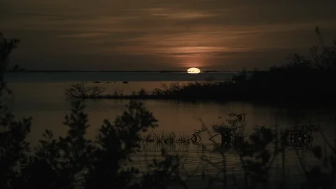 Sun setting over lake Stock Footage 97603871