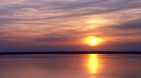 Sun Setting Over a Lake with Jetskies Stock Footage 44420355