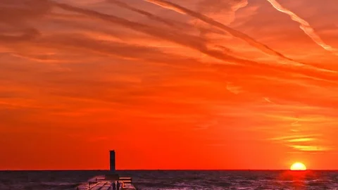 Sun Setting Over Lake Michigan's Grand Haven North Pierhead Video stock 115849523