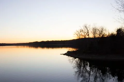Sun setting over lake Stock Photos