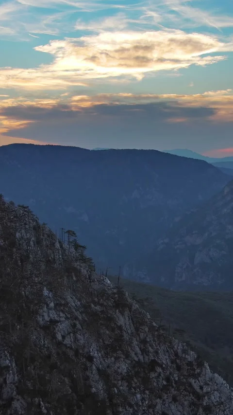 Sun setting over mountain with dramatic clouds. Evening sky at sunset. Durmitor Stock Footage 339223863