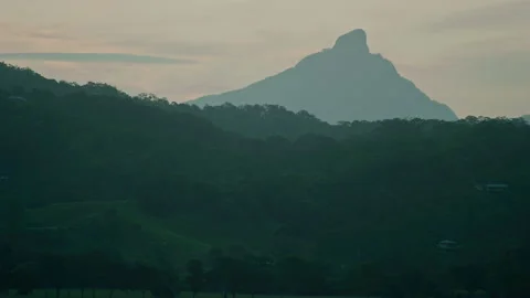 Sun setting over Mt Warning sacred aboriginal location in Australia Stock Footage 153230427