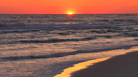 Sun setting over the ocean and sandy beach Stock Footage 38175622