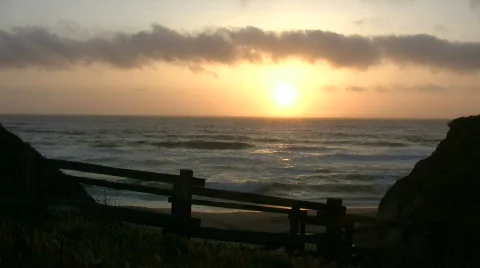 Sun is setting over the ocean in this beach scenic Stock Footage 360759