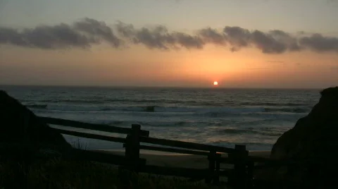 Sun is setting over the ocean in this beach scenic Stock Footage 360760