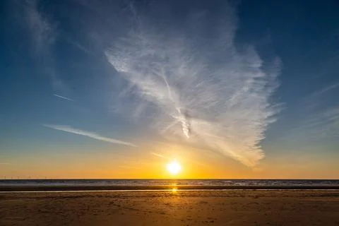 The sun setting over the ocean, at Formby in Merseyside Stock Photos