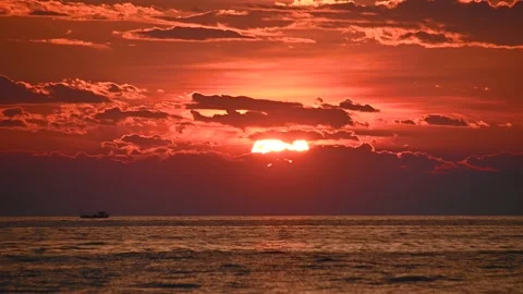Sun setting over the ocean with orange sky Stock Footage 156404627