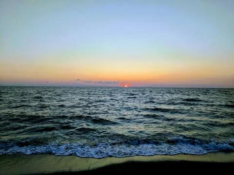 Sun Setting Over the Ocean Stock Photos