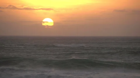 Sun setting over the ocean with waves in the foreground, Cape Town,South Africa Vídeo Stock 51171939