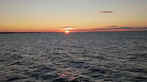 Sun Setting over the Open Ocean with Occasional Birds Flying Through Video stock 256875131