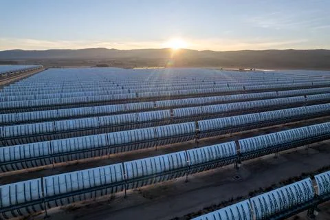 Sun setting over the parabolic trough field, Villena solar plant Фото