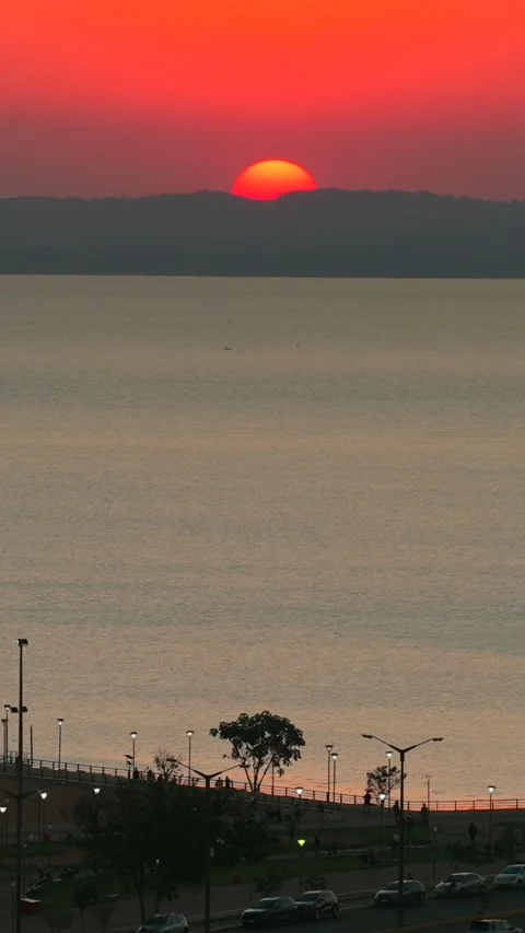 Sun setting over Parana river, Posadas, Argentina skyline at dusk with Video stock 332059279