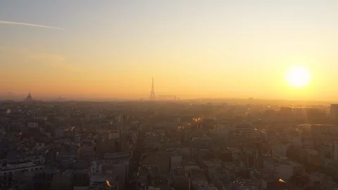 Sun setting over Paris Skyline Eiffel Tower rooftops France capital  Stock Footage 122923412