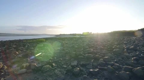Sun setting over pebble beach Stock Footage 66777583