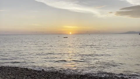 Sun Setting over a Pebble Beach, Puerto Vallarta Stock Footage 345551685
