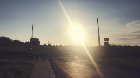 Sun setting over railroad crossing in the village Video stock 116233689