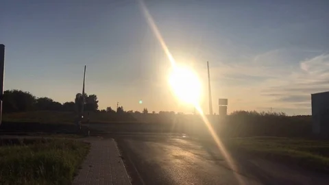 Sun setting over railroad crossing in the village Stock Footage 116233693