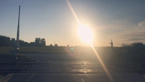 Sun setting over railroad crossing in the village Stock Footage 116233746