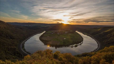 The sun is setting over a river landscape Stock Footage 52370202