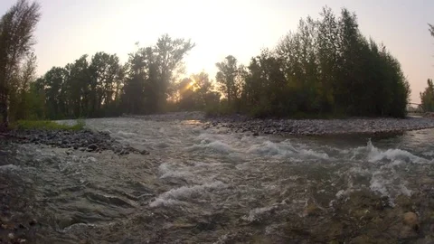 Sun setting over river near water Stock Footage 73051269