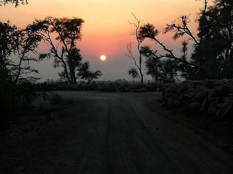 Sun Setting Over Sandy road Stock Photos