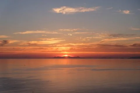Sun setting over the sea Stock Photos