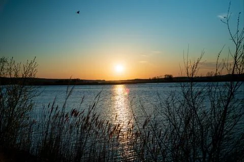 Sun Setting Over A Small Lake Фото
