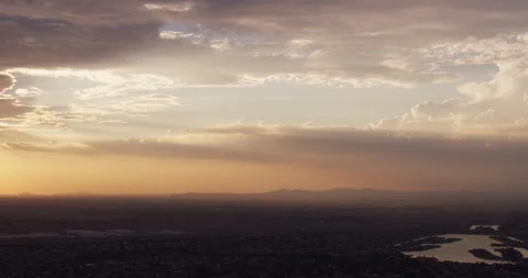Sun setting over suburban landscape and small lake, aerial shot Video stock 104673546