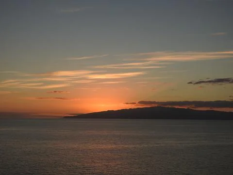 Sun setting over water Stock Photos