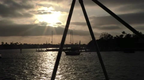 Sun setting passes through Bimini supports sunrays through clouds amazing pan Video stock 67468859