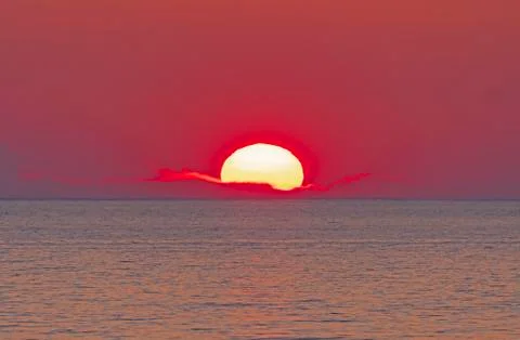 The Sun Setting into a PIllow Of Clouds Photos