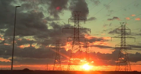 Sun Setting on Power Lines Passing by Quickly on the Side of the Road Stock Footage 83471452