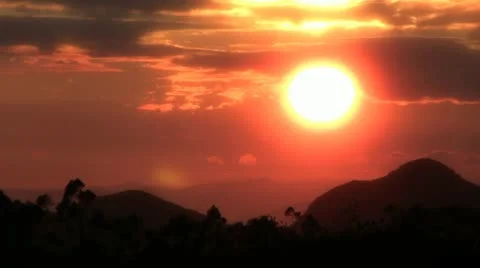 Sun setting in a red sky Stock Footage 11314792