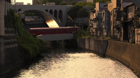 Sun setting on a river with rail bridge, red train passing though, Stock Footage 267689990