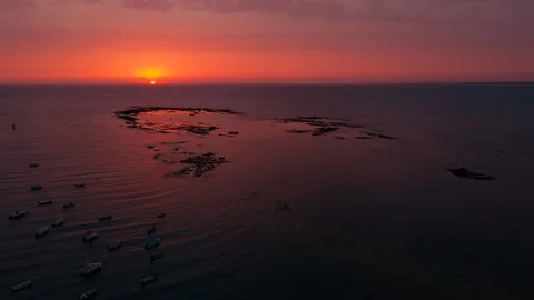 Sun setting into the sea 4K aerial Stock Footage