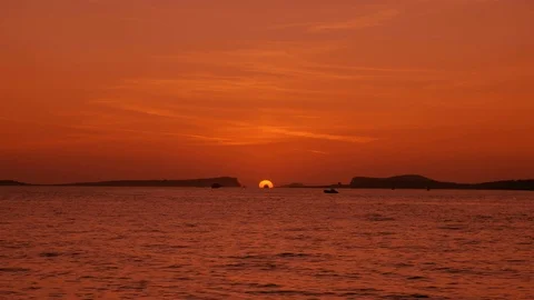 Sun setting into the sea between mountains islands Stock Footage 123090414