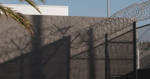 Sun setting Through Barbed Wire And Fence, Prison Border, Security Stock Footage 166664973