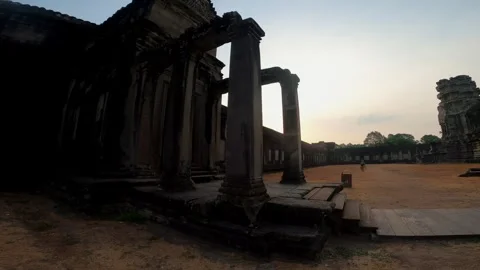 Sun Setting Through Columns of Ancient Temple Ruins Stock Footage 343129299